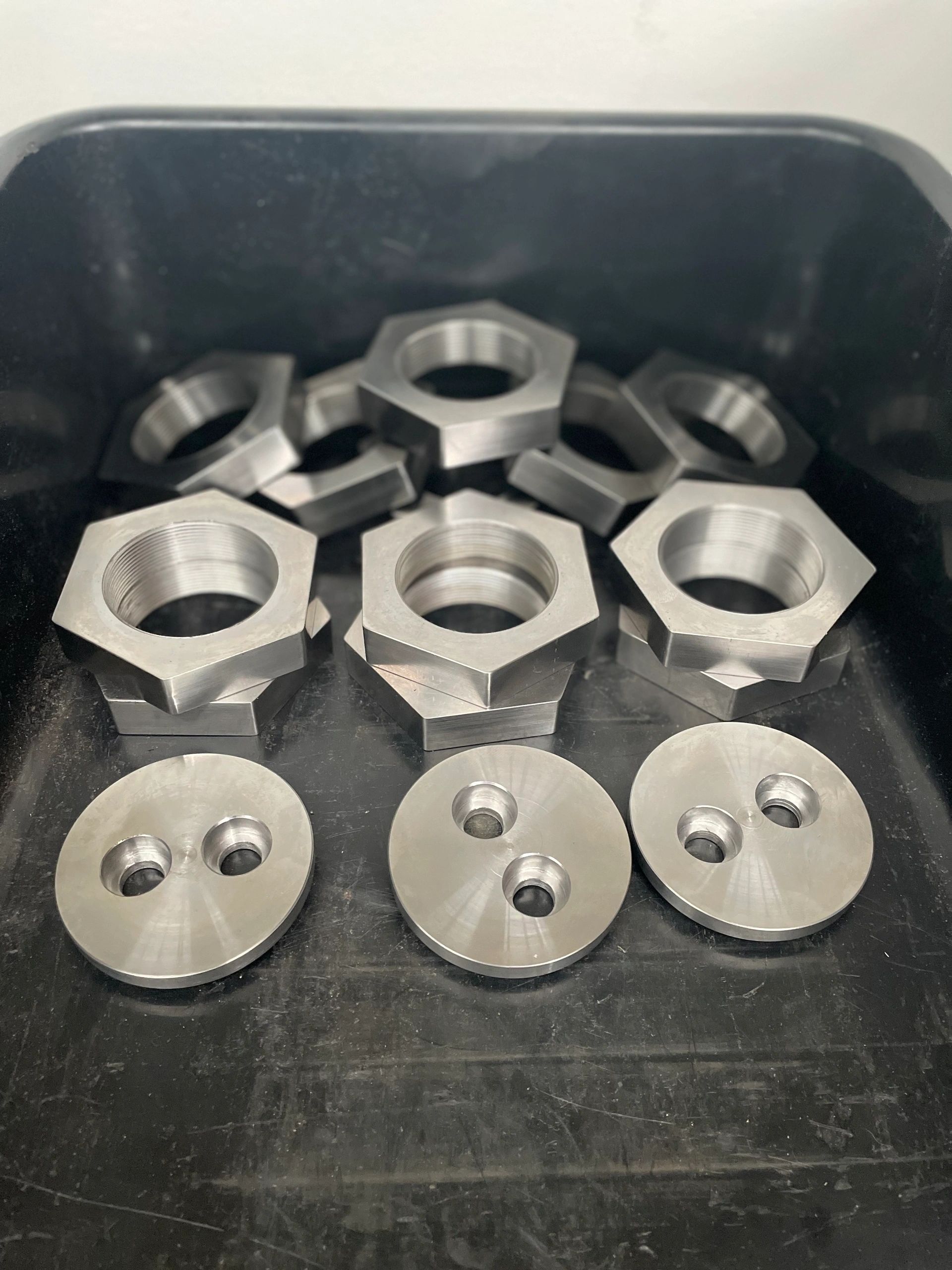 Hex nuts and flange caps in production tub