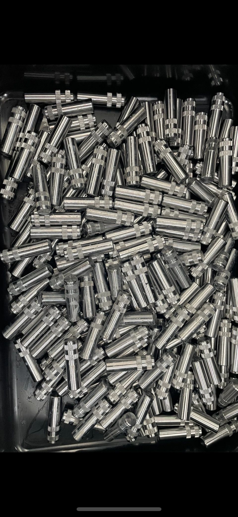 Bin of knurled stainless pins