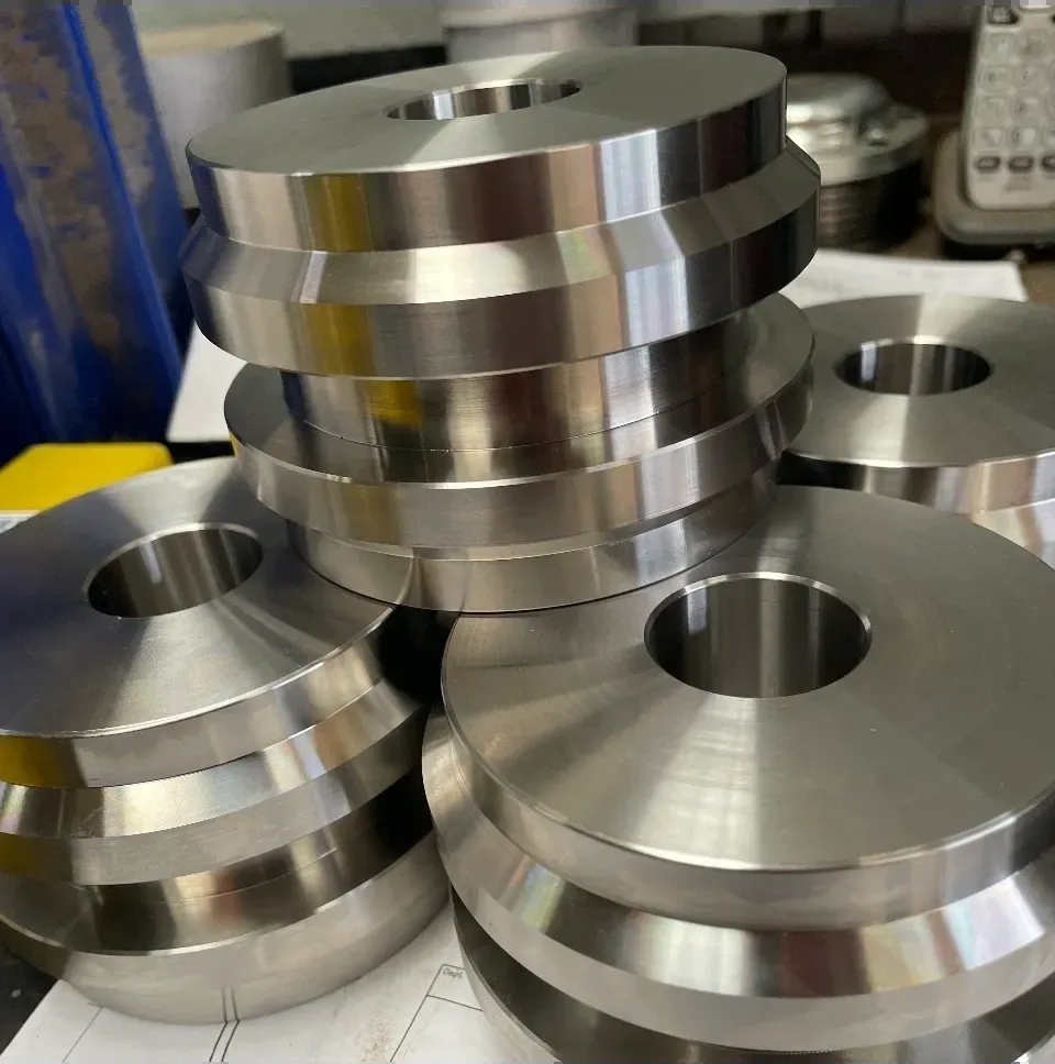 Stack of large stepped steel flanges with central bore