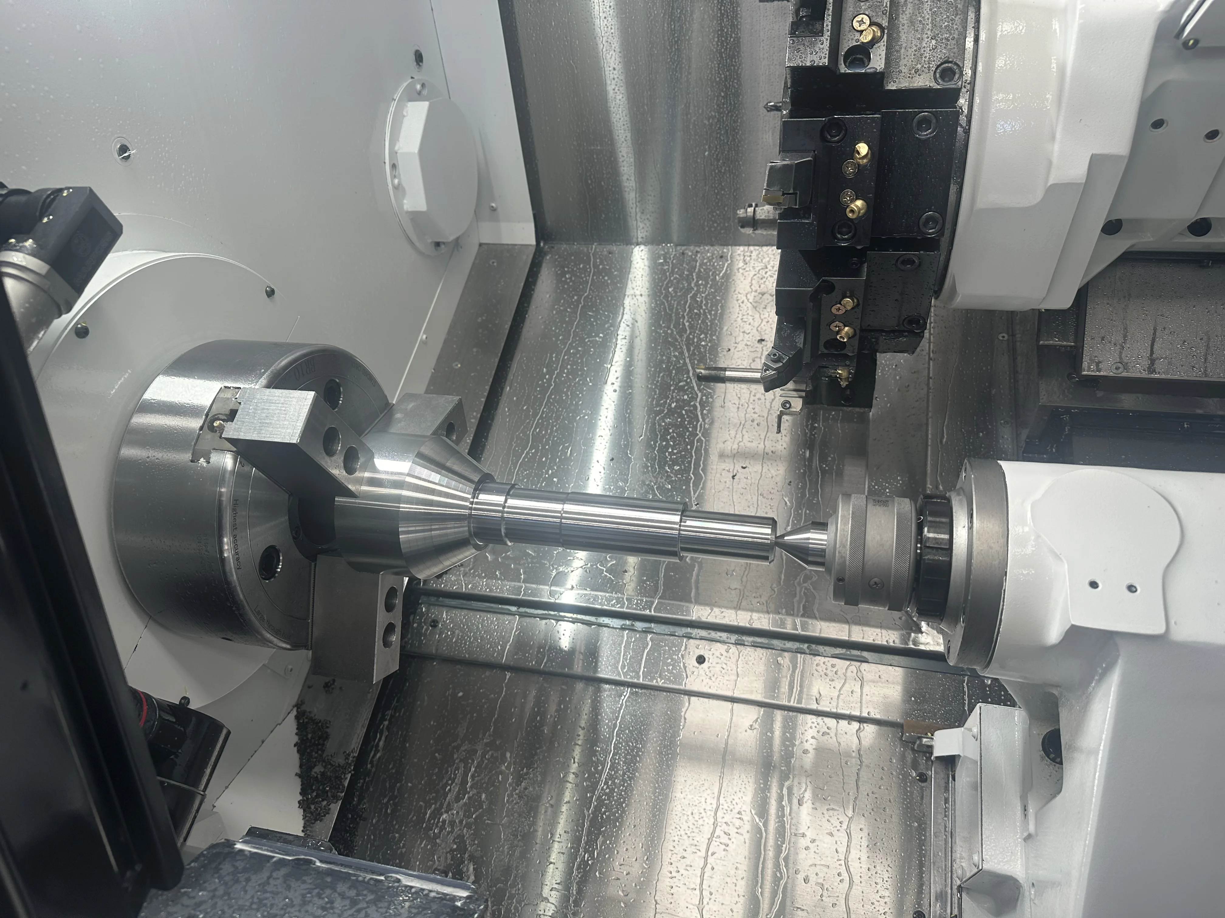 CNC lathe holding shaft between chuck and tailstock, Padco Engineering