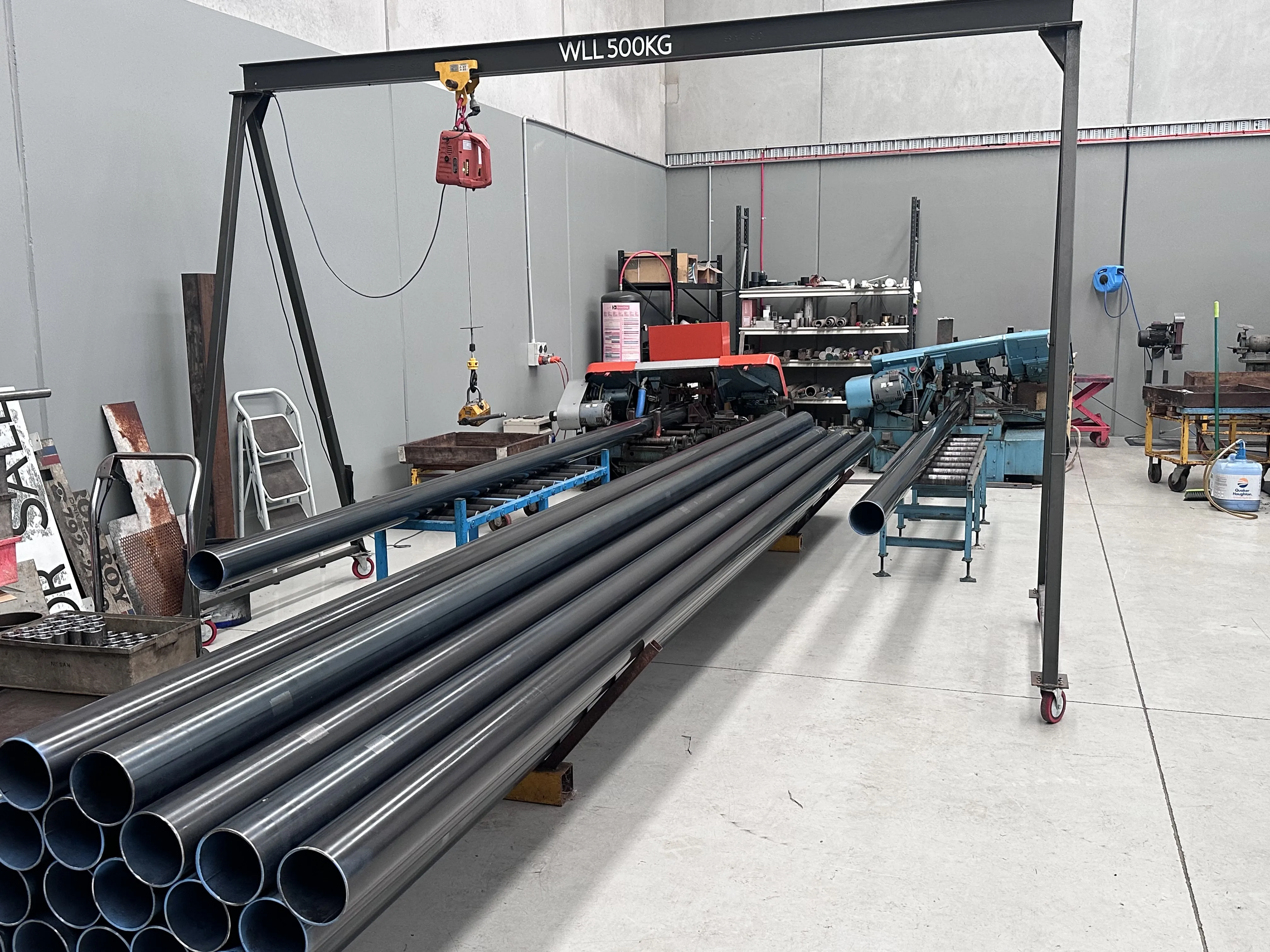 CNC bandsaw cutting bar stock, Padco Engineering workshop