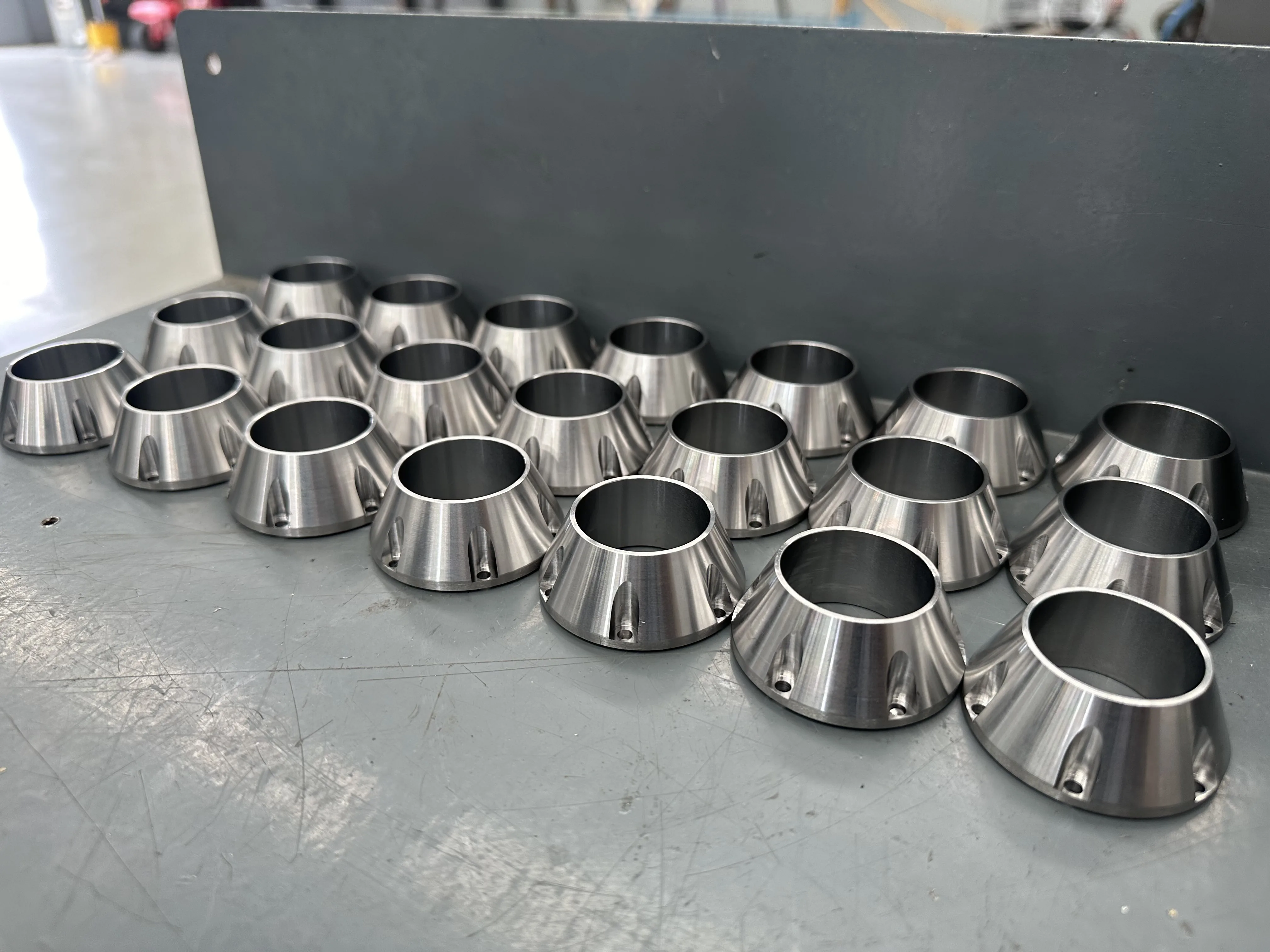 Batch of precision-machined conical stainless components — production run, Padco Engineering