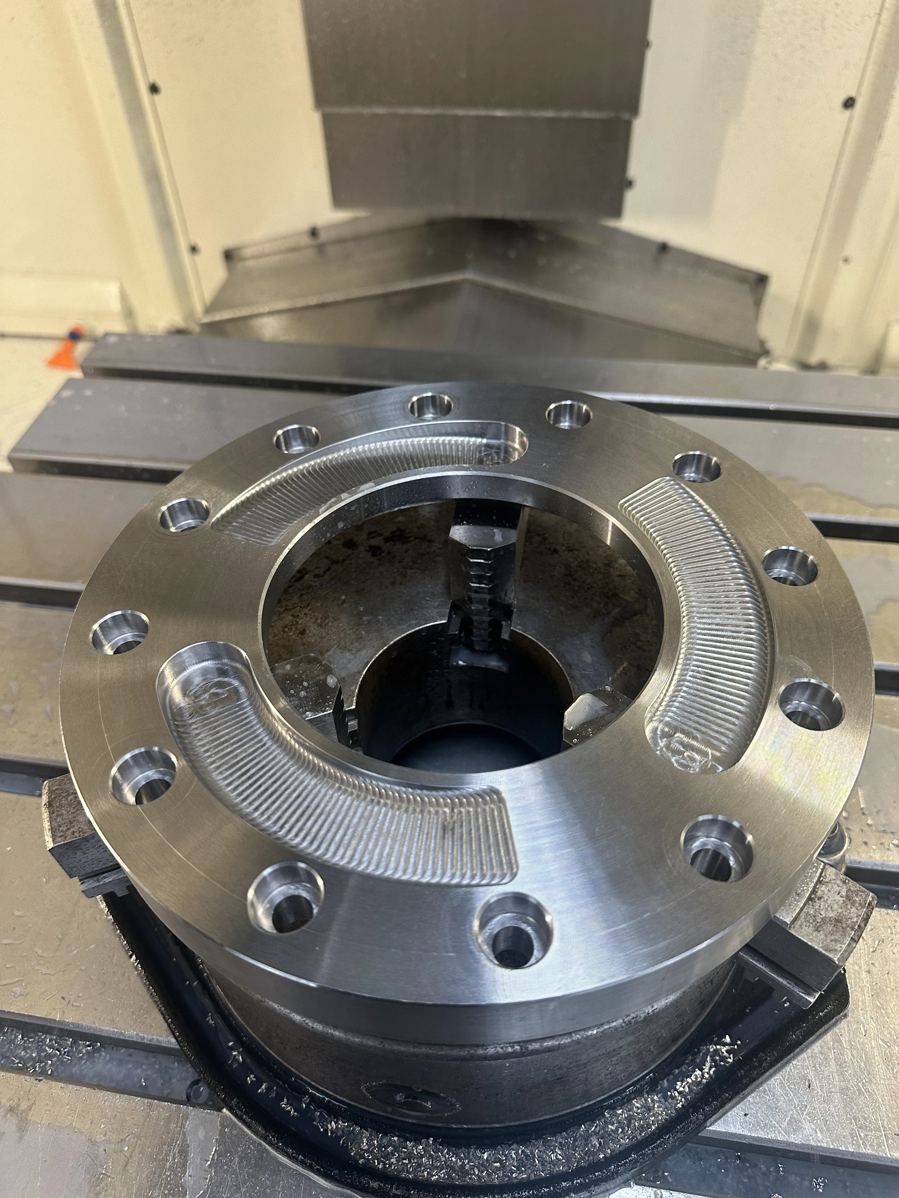 Machined steel circular flange on CNC mill bed, Padco Engineering